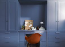 A home office space painted in a smoky blue shade