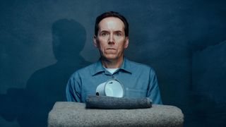 Ben Miller as "Professor T" in denim shirt over white t-shirt, pictured with prison-issue kit as if for inspection