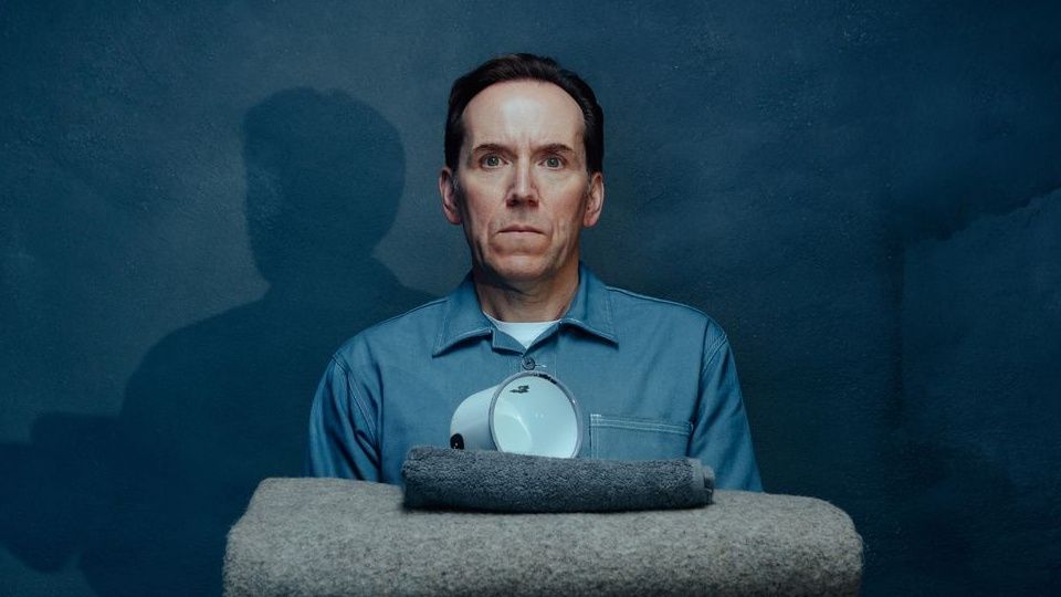 Ben Miller as &quot;Professor T&quot; in denim shirt over white t-shirt, pictured with prison-issue kit as if for inspection