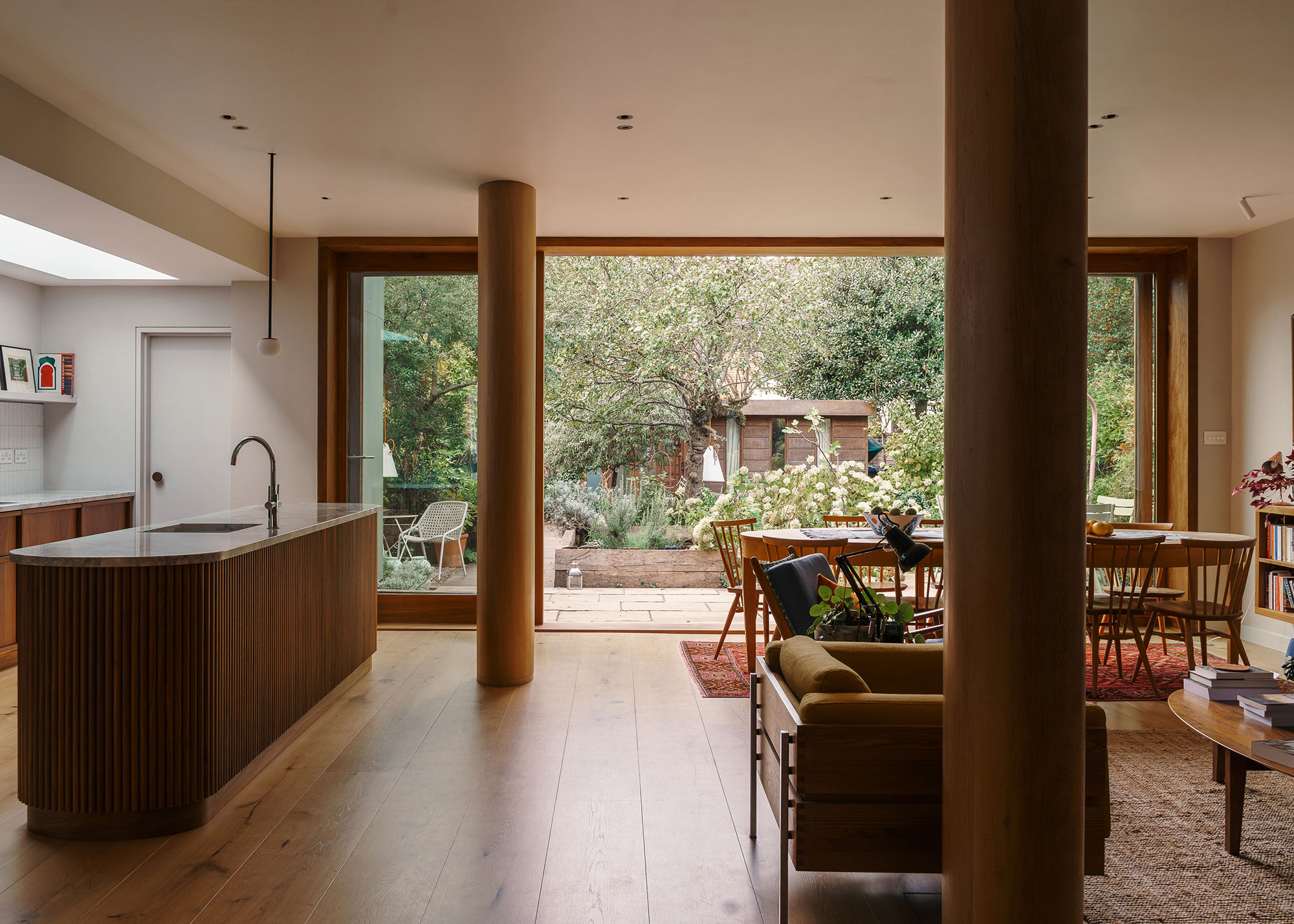open plan kitchen dining and living room with fluted kitchen island