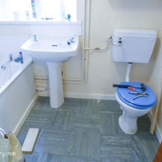 bathroom with white sanityware and pipework