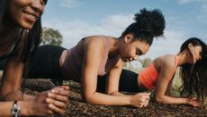 Three woman in a sunny outdoor environment Planking - stock photo