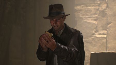 Indy looking at a gold artefact during one of the best Xbox Series X games, Indiana Jones and the Great Circle