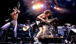 (from left) AC/DC's Bon Scott, Malcolm Young, Phil Rudd, Angus Young and Cliff Williams perform at the Orpheum Theater in Boston, Massachusetts on October 9, 1978