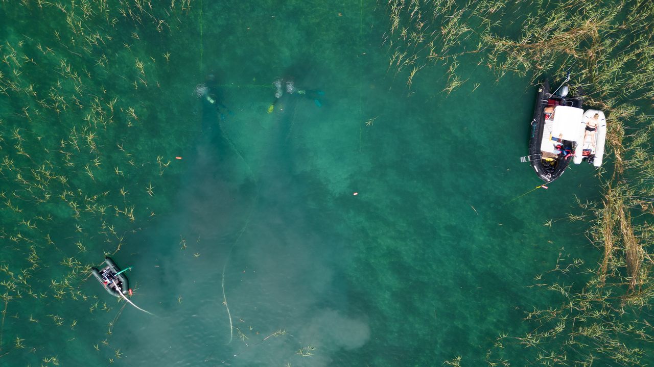 Divers excavate underwater site at possible oldest village in the world.