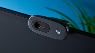 a small, black, oblong-shaped webcam with a universal attachment clip and a logi logo 