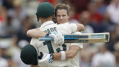 Australia batsman Steve Smith celebrates his century with team-mate Matthew Wade 