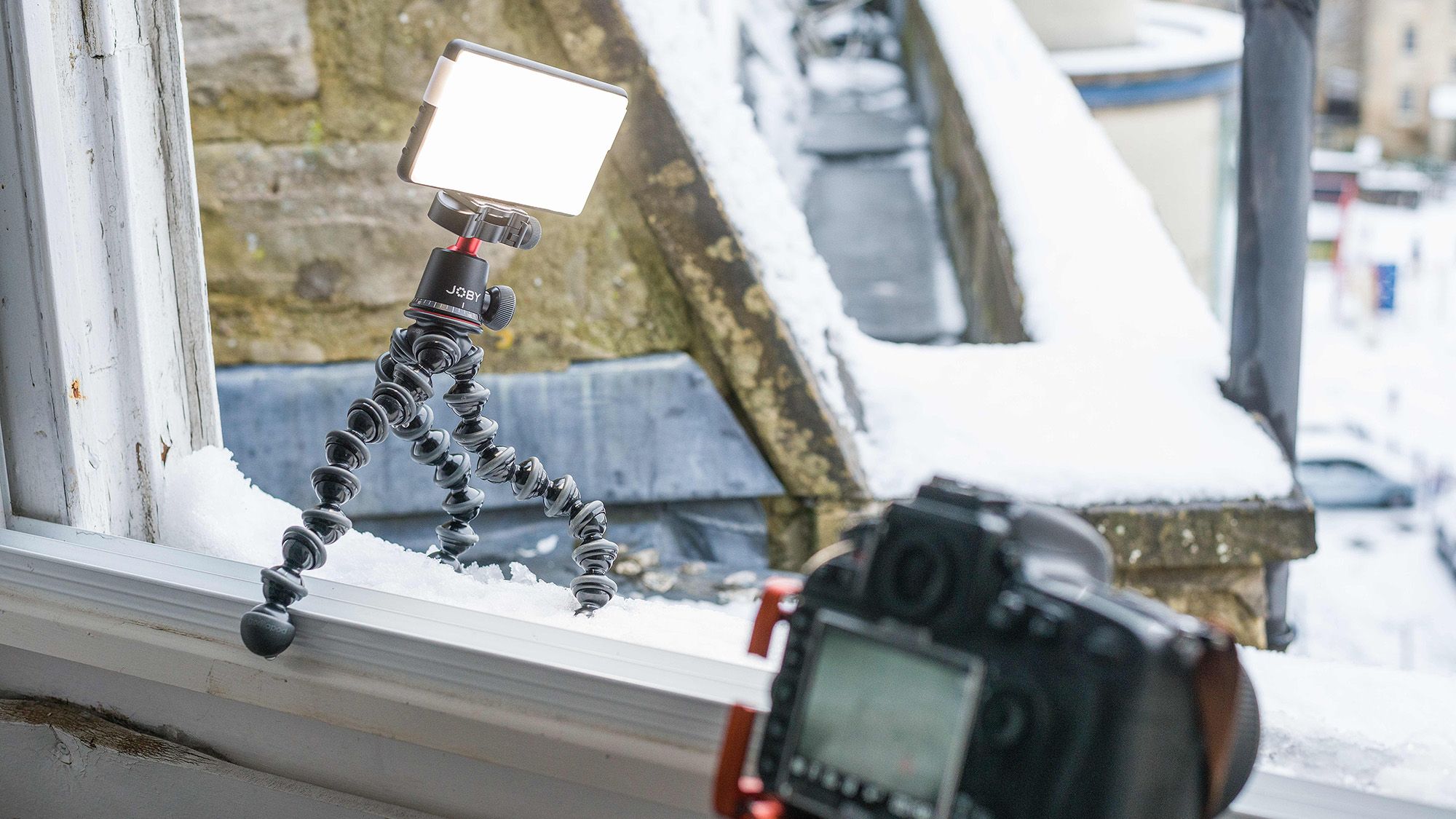 LED light panel on a Joby GorillaPod on a snow-covered window sill with Nikon D800 in the foreground