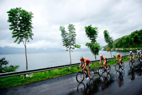 Riders pass the shore of lake Singkarak