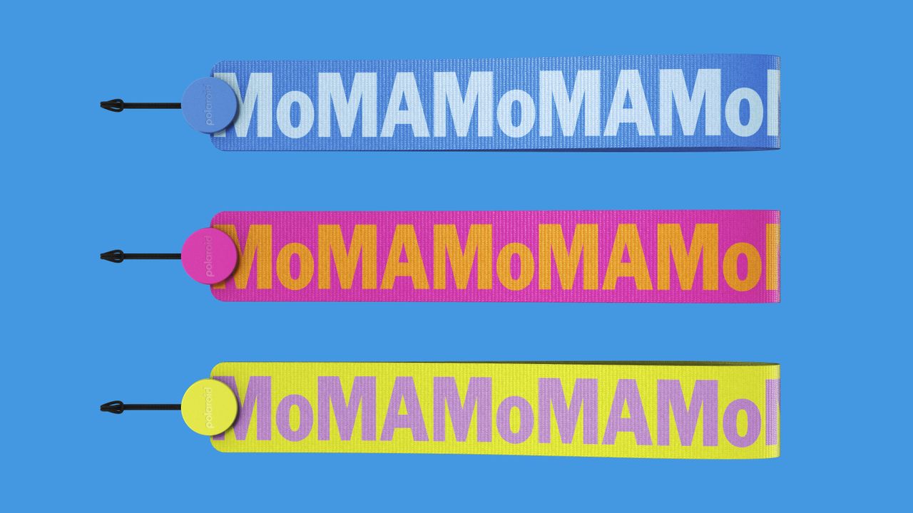 Polaroid Now Instant Camera Generation 3 - MoMa Edition camera straps against a blue background