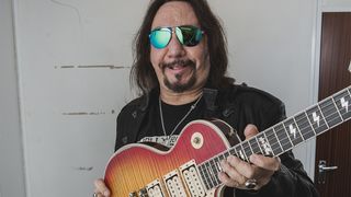 Ace Frehley holding a sunburst Gibson Les Paul