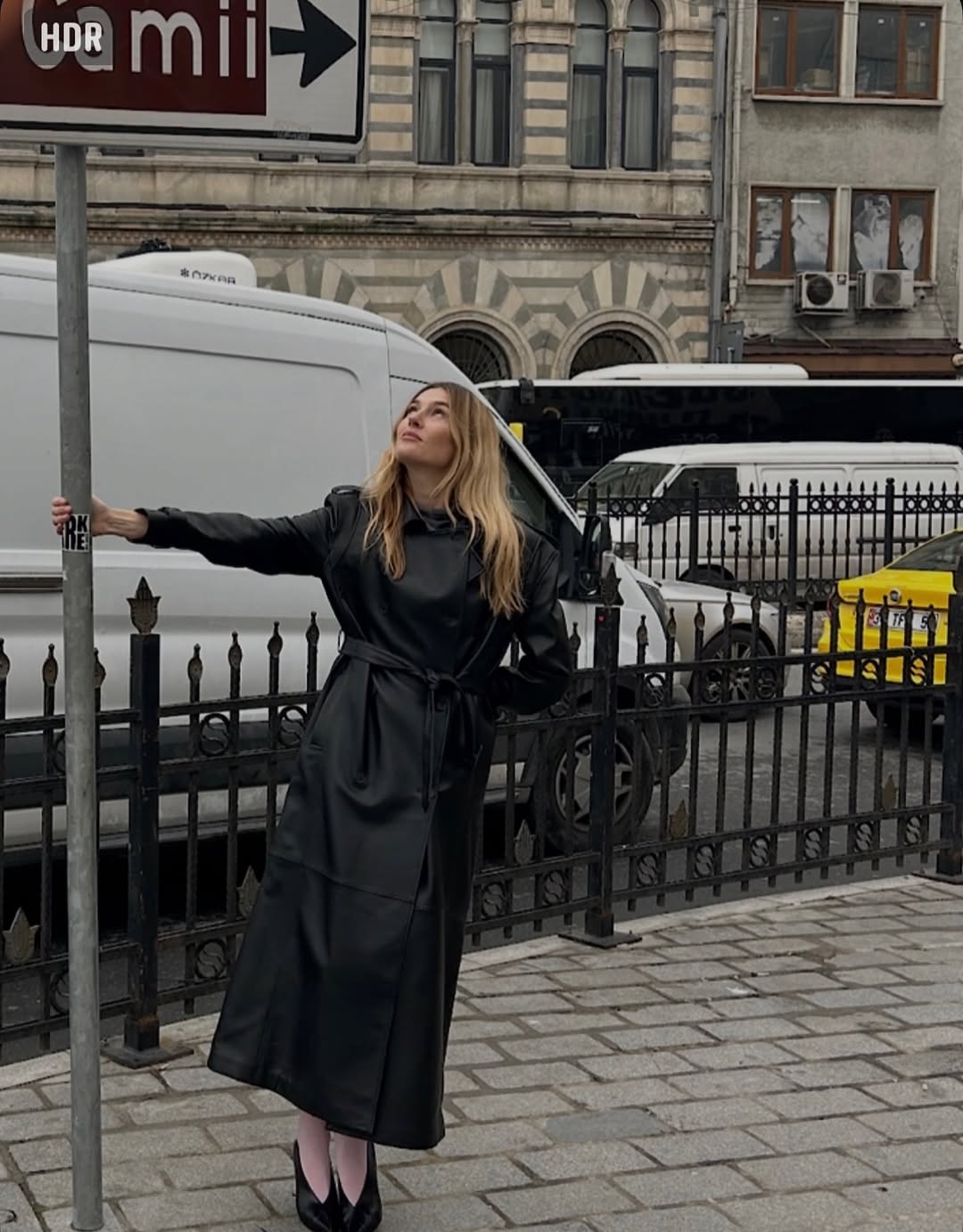 Camille Charriere wearing a trench coat.