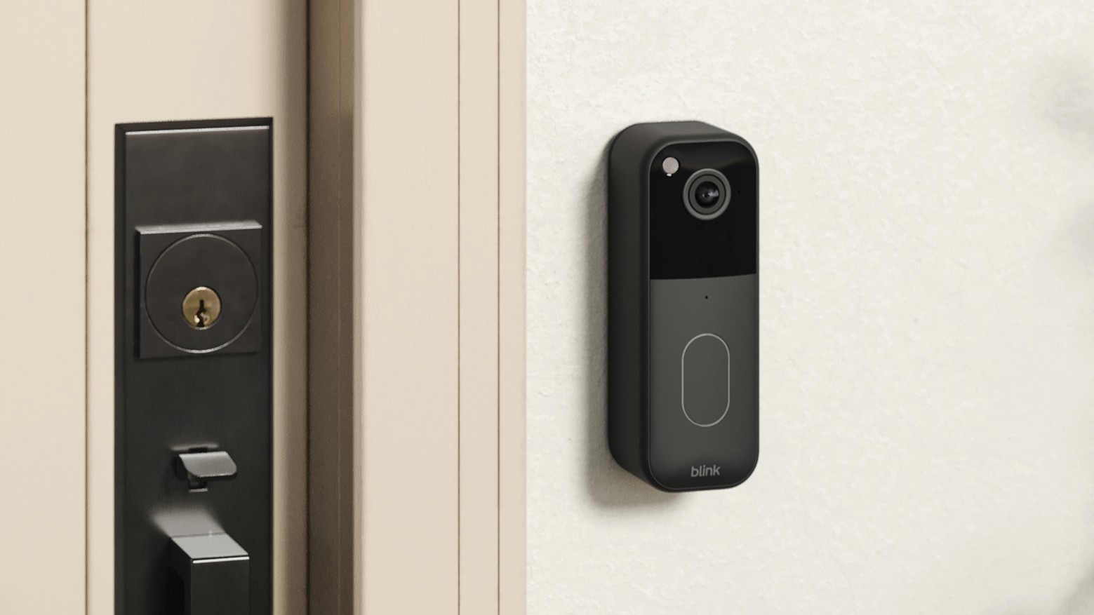 Blink Video Doorbell mounted on wall beside door