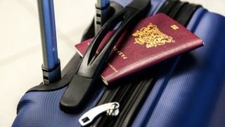 Image of a passport on top of a suitcase