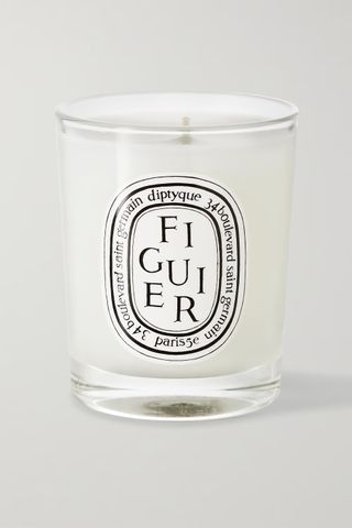 A small candle in a glass votive