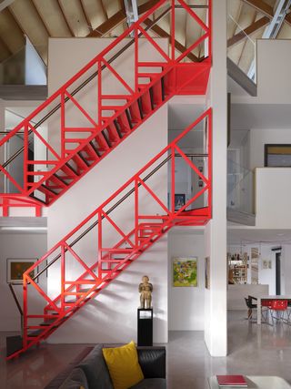 station lodge an unusual london home with a huge grey pitched roof and a red staircase