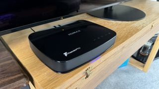 Close up of Humax Aura smart PVR on wooden unit