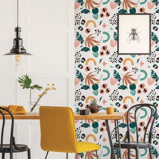 dining room with wallpaper and dining table