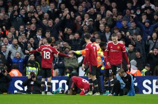 Manchester United’s Anthony Elanga (on floor, centre) was struck with a coin as his side celebrated a goal in front of Leeds supporters.