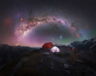 Milky way arc photographed above a lone camping tent on top of Aoraki/Mt Cook National Park, New Zealand