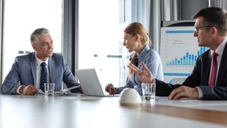 A woman and two men having an important business discussion