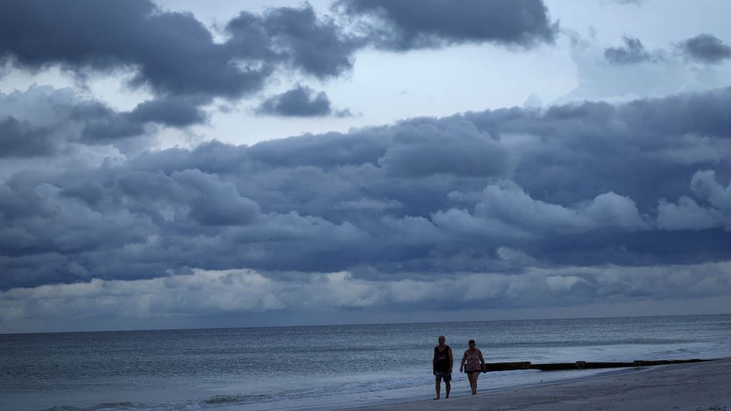 People walk on a Florida beach ahead of Hurricane Ian&amp;#039;s arrival.