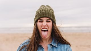 Should you brush your tongue: image of woman sticking tongue out