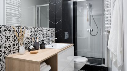 Small bathroom with black and marble walls