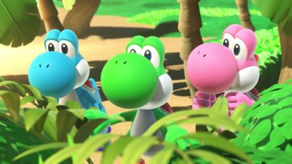 In Yoshi and the Mysterious Book, Pink, Blue, and Green Yoshi stand together looking out over some foliage 