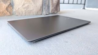 A closed Samsung Galaxy Book5 Pro on concrete.