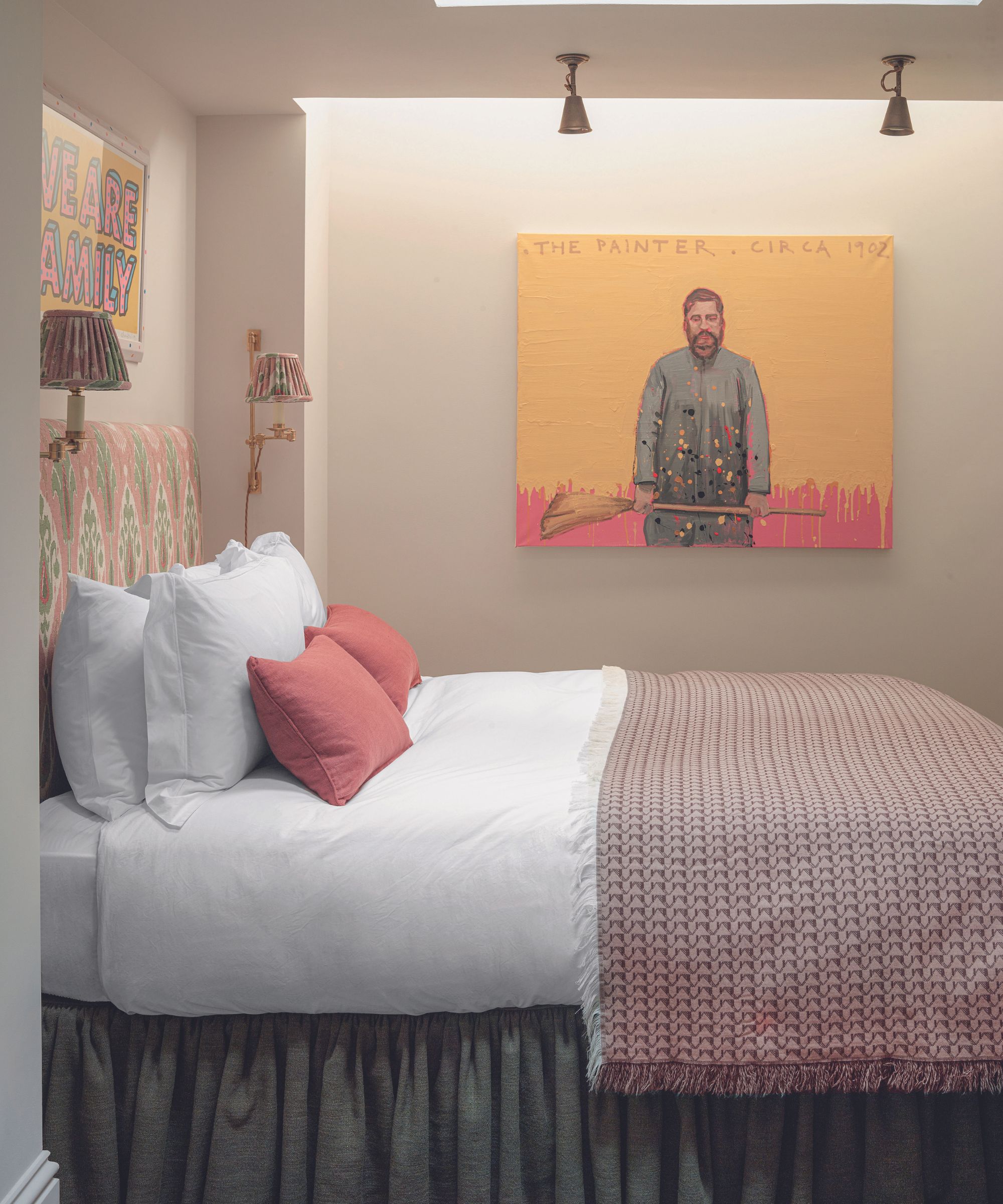 Beige bedroom with pink bedding and yellow artwork