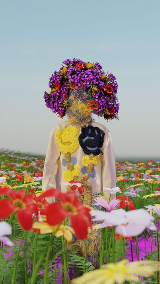 A person standing in a meadow of flowers wearing a colourful top and a flowered hat.
