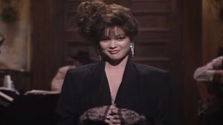 Valerie Bertinelli stands on stage smiling during her monologue on Saturday Night Live - S12 E13.