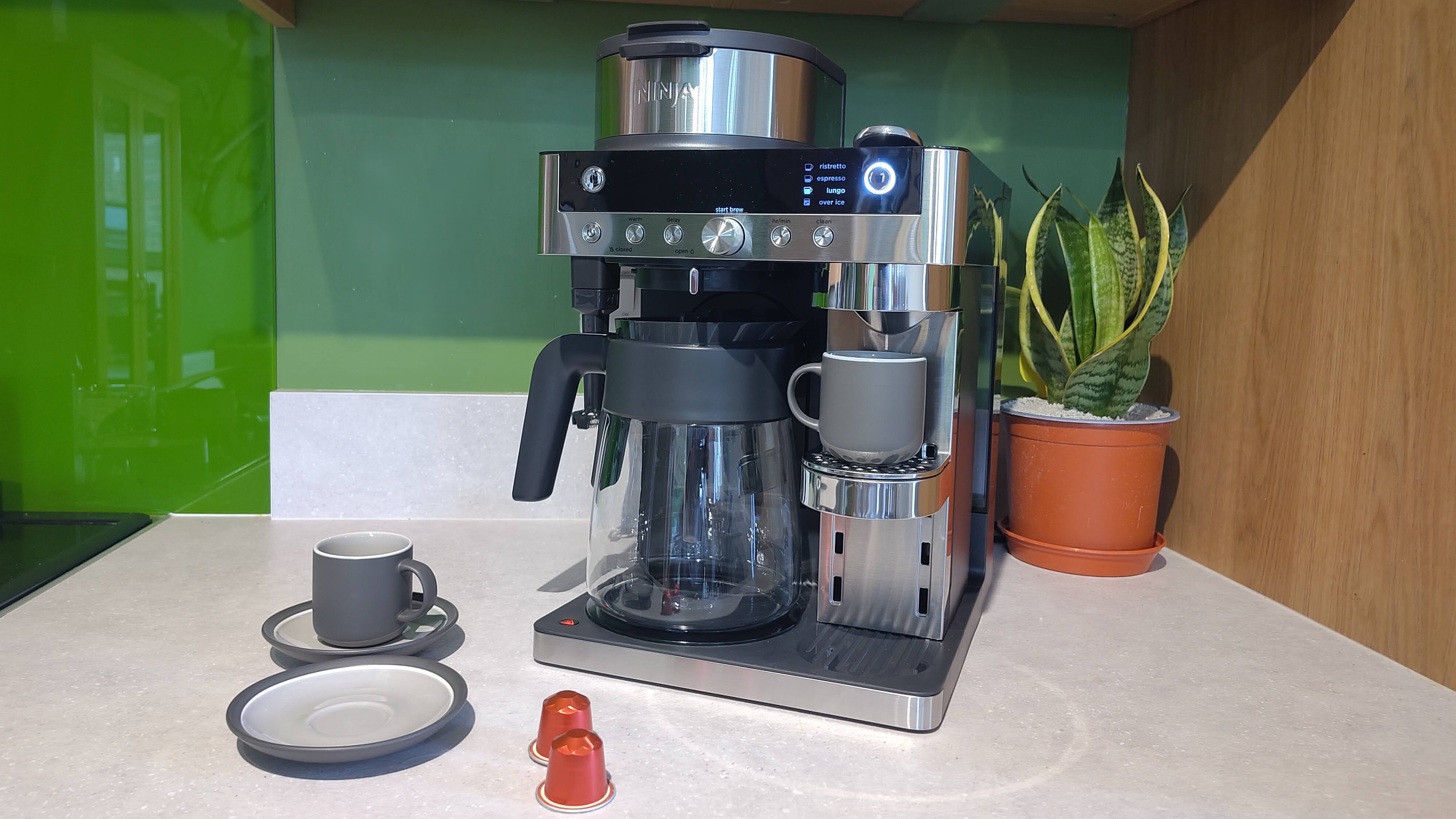 Ninja Prestige Dual-Brew System with coffee pods and espresso cups on kitchen counter