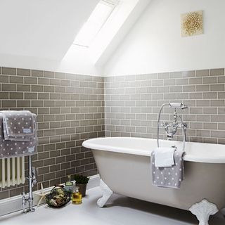 attic bathroom with grey bath and tiles