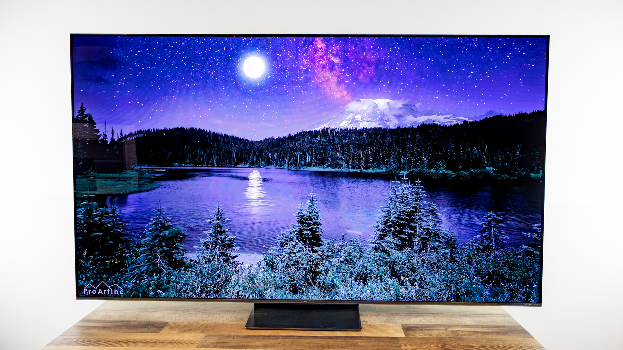 TCL QM7L 75-inch TV on a desk