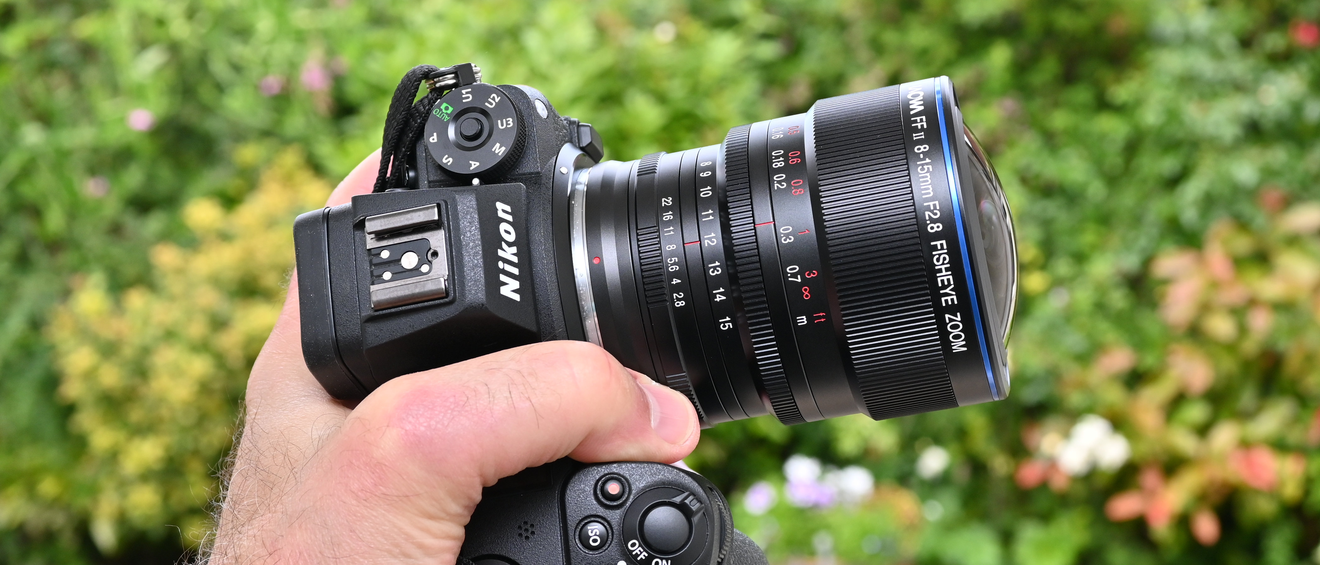 Laowa 8-15mm f/2.8 FF Zoom Fisheye product image of lens held in hand