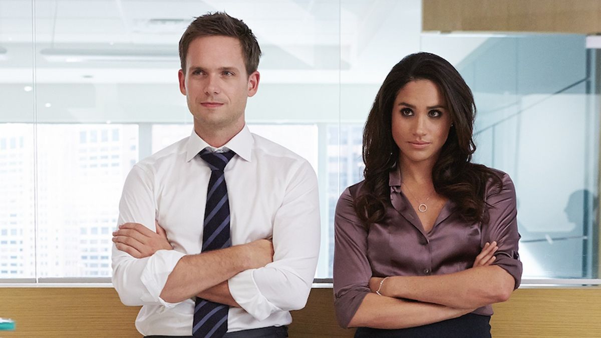 Patrick J. Adams and Meghan Markle crossing their arms on Suits.