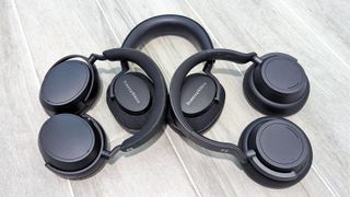 Collection of three over-ear headphones arranged on a floor 