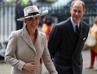 Duchess Sophie, wearing a gray coat and white hat, and Prince Edward walking into Westminster Abbey on Commonwealth Day 2024