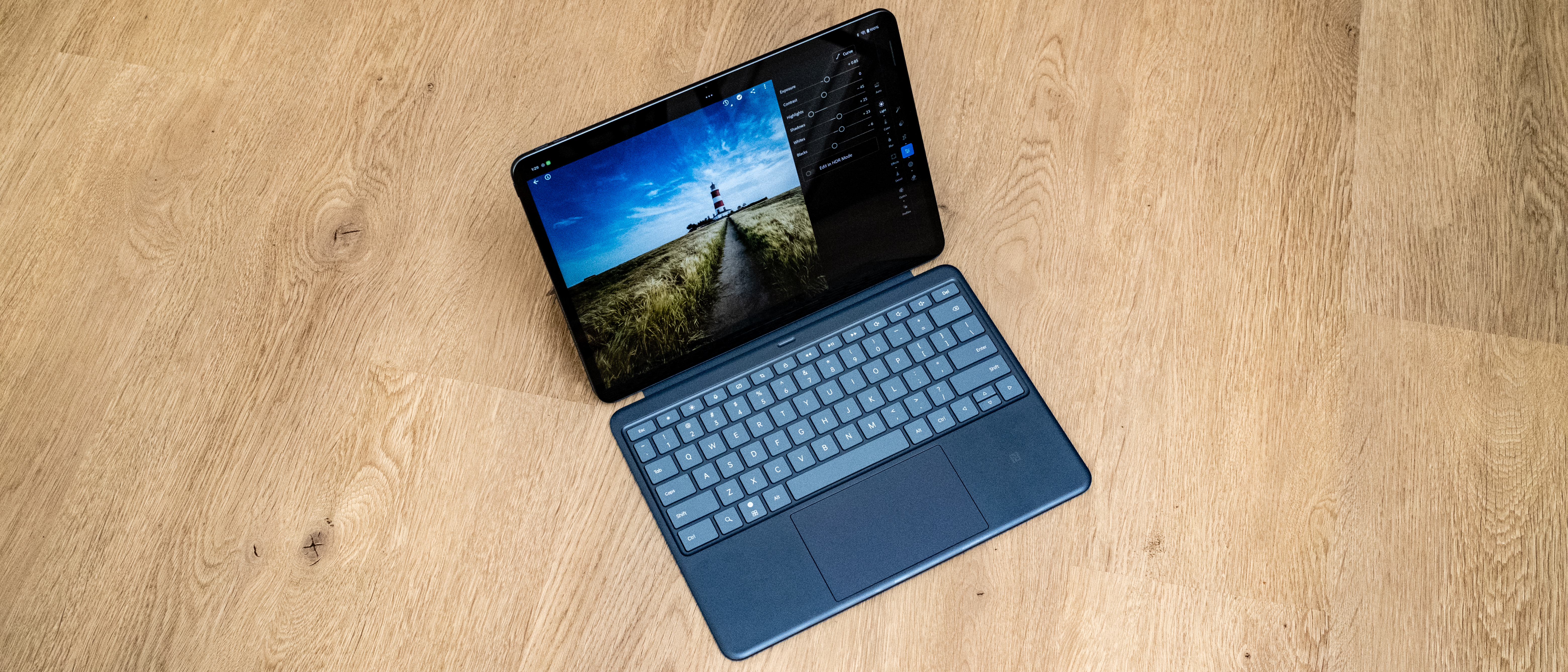 OnePlus Pad 3 and keyboard case on a wooden floor