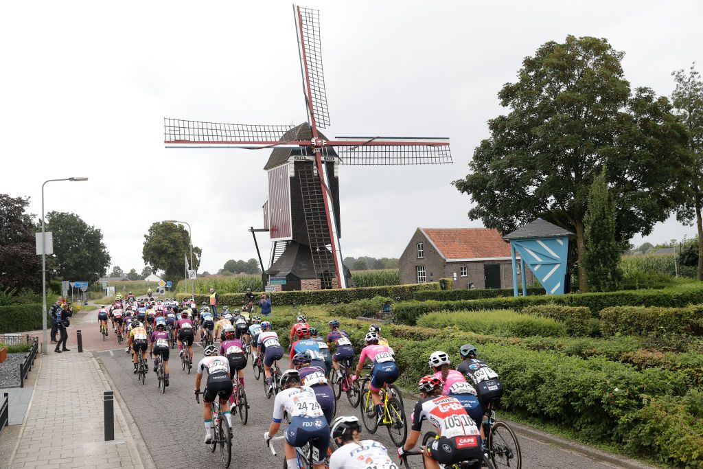 WEERT NETHERLANDS AUGUST 27 A general view of the peloton passing through a windmill landscape during the 23rd Simac Ladies Tour 2021 Stage 3 a 1259km stage from Stramproy to Weert SLT2021 UCIWWT on August 27 2021 in Weert Netherlands Photo by Bas CzerwinskiGetty Images