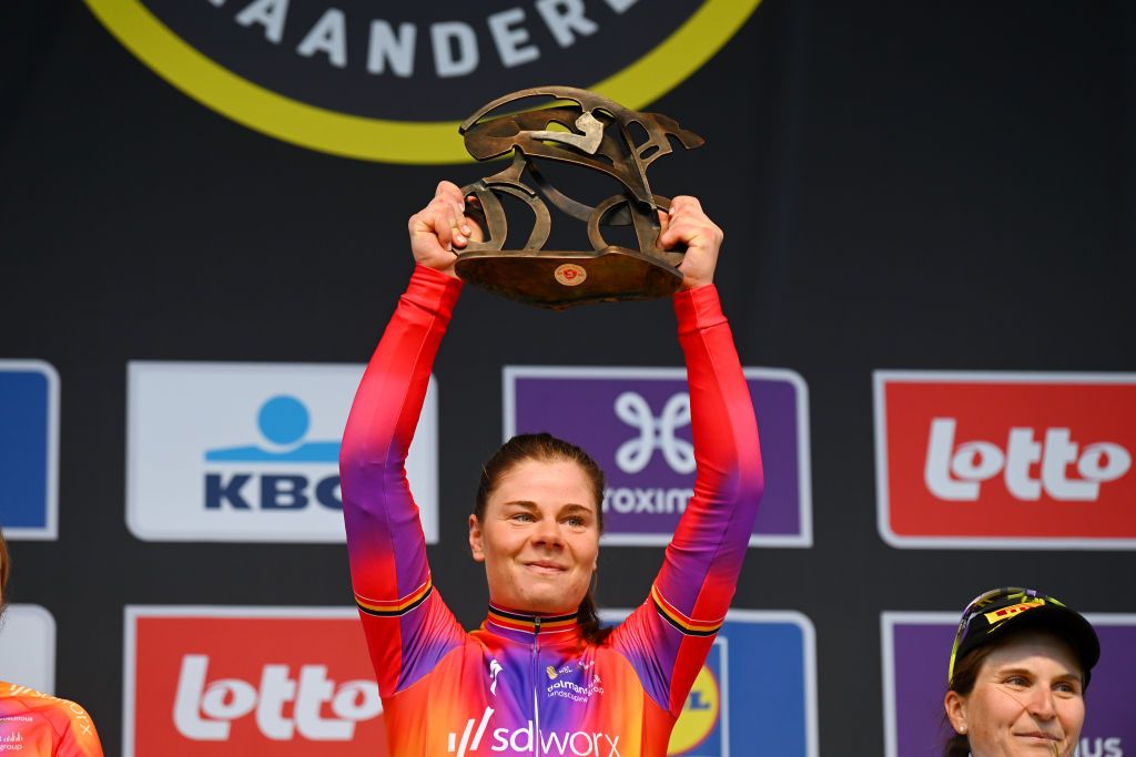 Lotte Kopecky (SD Worx) holds the Tour of Flanders winners trophy aloft in 2023 for a second year in a row