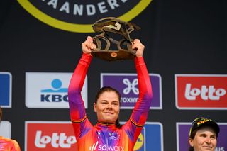 Lotte Kopecky (SD Worx) holds the Tour of Flanders winners trophy aloft in 2023 for a second year in a row