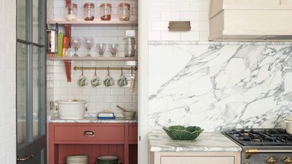 pantry with white subway tiles in modern kitchen with pink cabinetry and marble