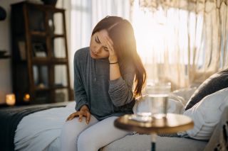 Can you use massage for headache relief? Woman holding head