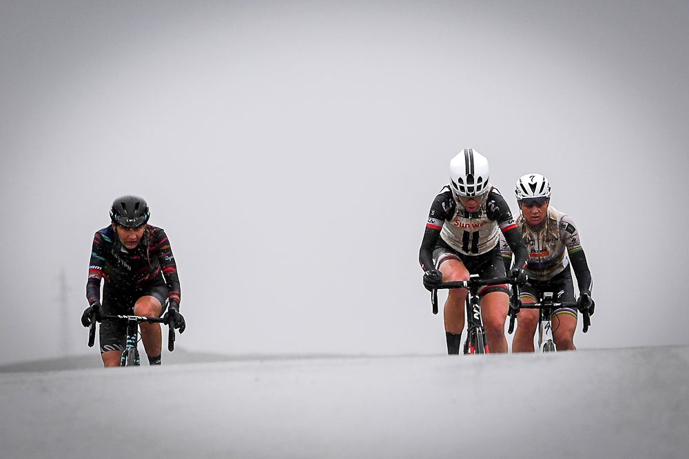 Alena Amialiusik, Eleonora van Dijk and Chantal Blaak crest a hill in Strade Bianche