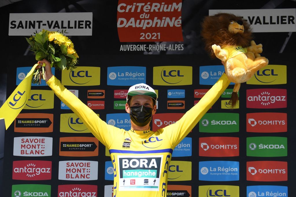 Team Boras Lukas Postlberger of Austria celebrates his overall leaders yellow jersey on the podium at the end of the fifth stage of the 73rd edition of the Criterium du Dauphine cycling race a 175km between SaintChamond and SaintVallier on June 3 2021 Photo by Alain JOCARD AFP Photo by ALAIN JOCARDAFP via Getty Images
