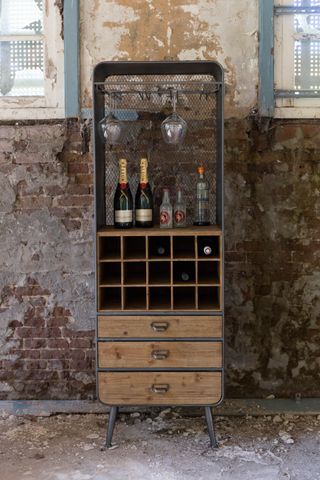 Dutchbone vintage French-style wine cabinet from Cuckooland by crumbling exposed brick wall