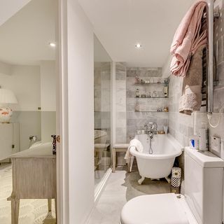 bathroom area with towel set and tiles on wall